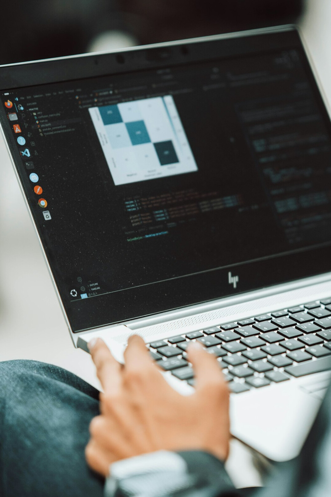 person writing code on laptop